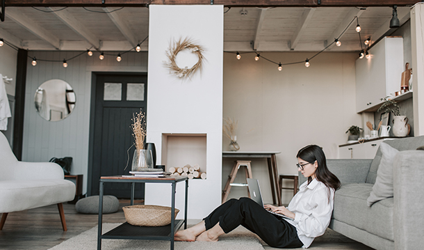 Stock image of someone sitting down, on their laptop